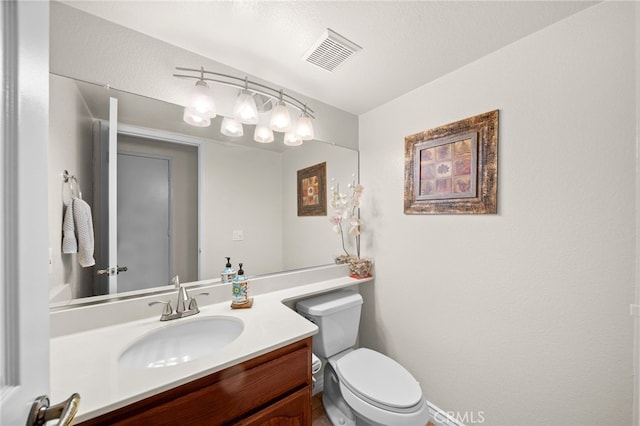 bathroom with toilet and vanity