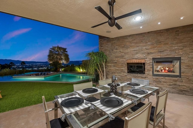 patio terrace at dusk featuring a fire pit