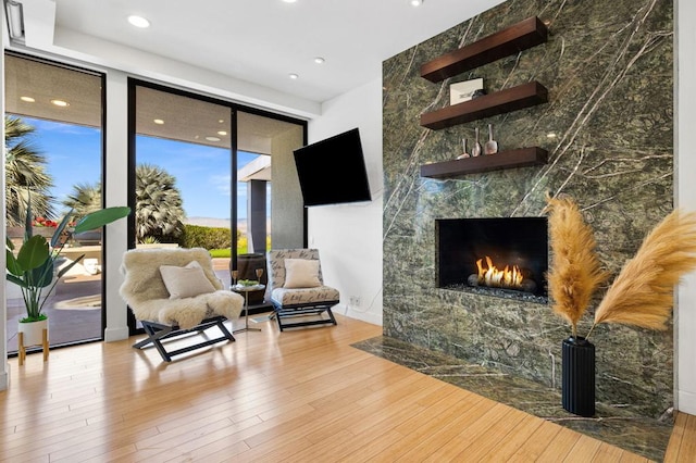 sitting room featuring a fireplace and light wood-type flooring