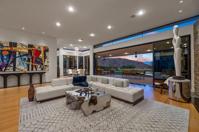 living room featuring a mountain view and light hardwood / wood-style flooring