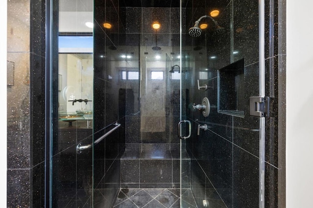 bathroom featuring a shower with shower door