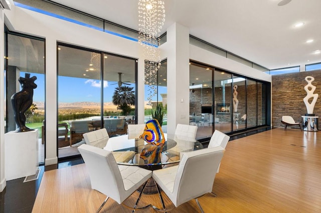 dining space featuring hardwood / wood-style flooring and a chandelier