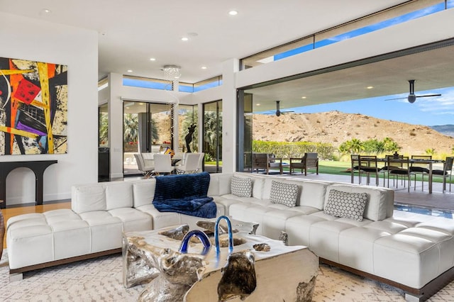 living room featuring a mountain view and ceiling fan