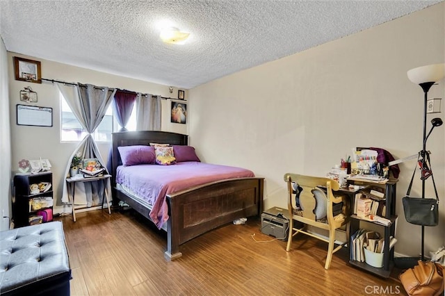 bedroom featuring hardwood / wood-style floors and a textured ceiling