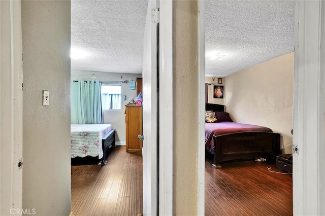 bedroom featuring wood-type flooring and a textured ceiling