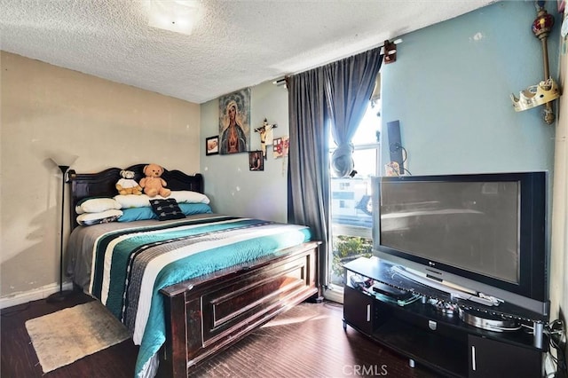 bedroom with wood-type flooring and a textured ceiling