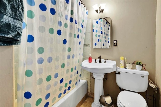 bathroom featuring shower / bath combination with curtain and toilet