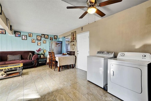 laundry room with a textured ceiling, ceiling fan, and washing machine and clothes dryer