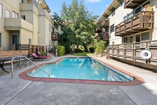 view of swimming pool with a patio