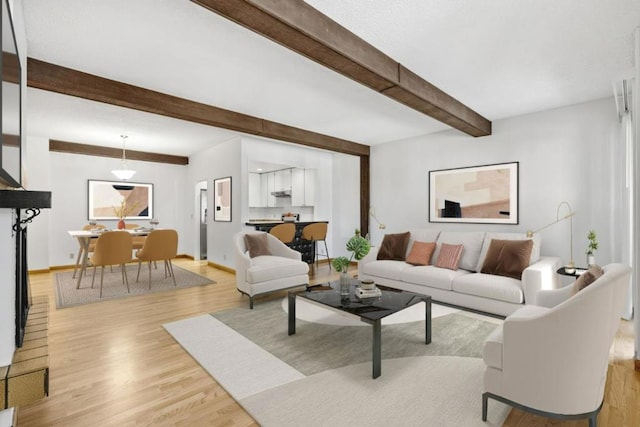 living room with beamed ceiling and light hardwood / wood-style flooring