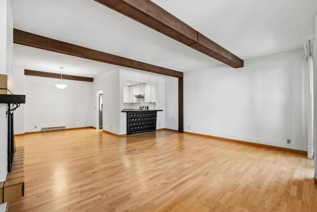 unfurnished living room with baseboard heating, light hardwood / wood-style flooring, and beamed ceiling