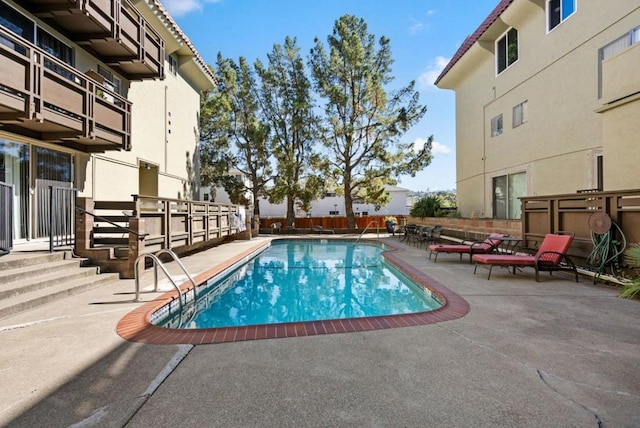 view of swimming pool with a patio