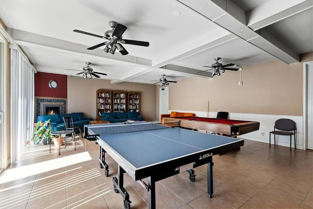 rec room with beam ceiling, billiards, and a tiled fireplace