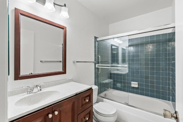 full bathroom featuring toilet, vanity, and combined bath / shower with glass door