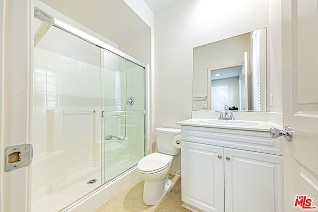 bathroom featuring toilet, walk in shower, and vanity