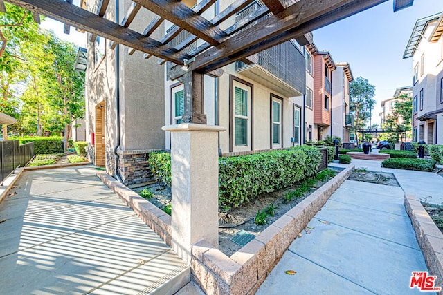 view of side of home featuring a pergola