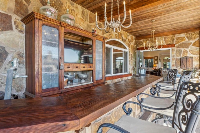 unfurnished dining area with a notable chandelier and wood ceiling