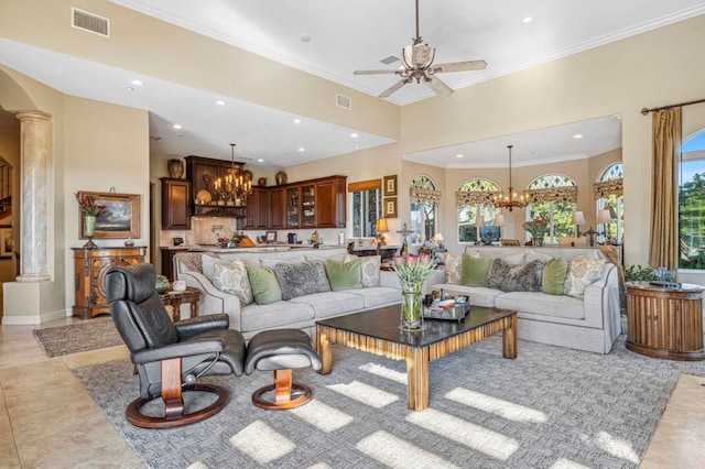 living room with light tile patterned floors, ceiling fan with notable chandelier, decorative columns, and crown molding