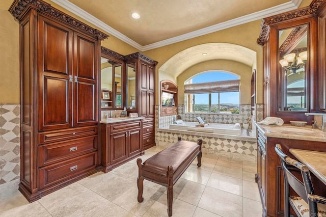 bathroom featuring tile patterned floors, crown molding, vanity, and a relaxing tiled tub