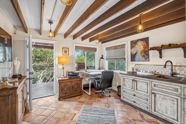 office space featuring beamed ceiling and sink