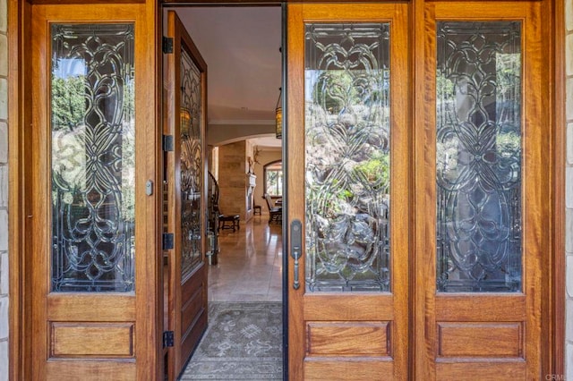 entryway featuring dark tile patterned flooring and french doors