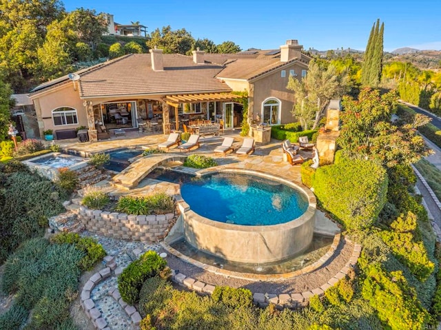 view of swimming pool with an in ground hot tub and a patio