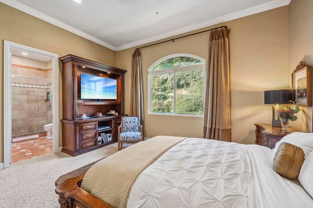 bedroom with crown molding, light carpet, and ensuite bath