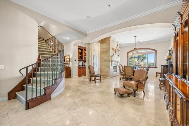 interior space with a large fireplace, light tile patterned floors, a chandelier, and ornamental molding