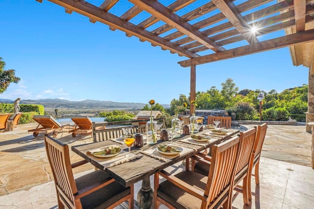 view of patio / terrace with a mountain view and a pergola