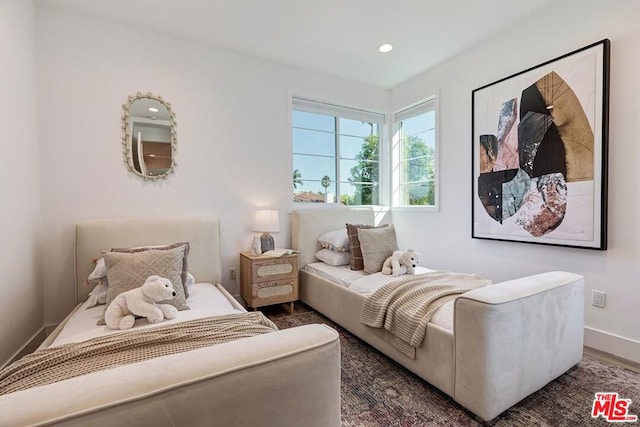 bedroom with dark hardwood / wood-style flooring