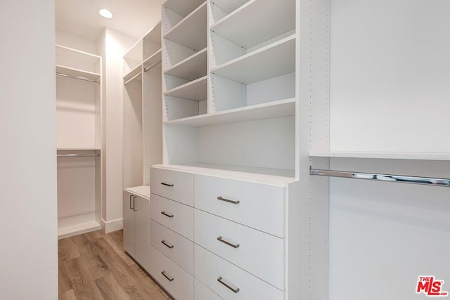 walk in closet featuring light hardwood / wood-style flooring