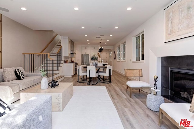 living room with a fireplace and light hardwood / wood-style flooring