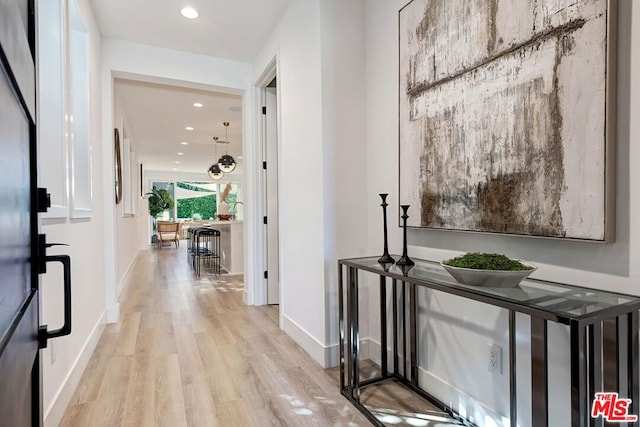 hallway with light hardwood / wood-style flooring