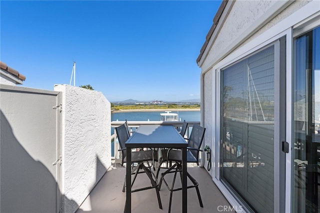 balcony featuring a water view