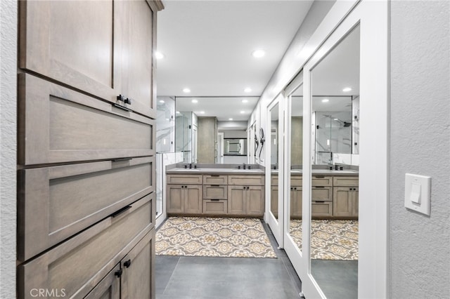 6 Kingston Ct E, Coronado, CA 92118 - bathroom with two vanities, a textured wall, recessed lighting, and a stall shower