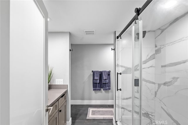 bathroom with vanity and a shower with shower door