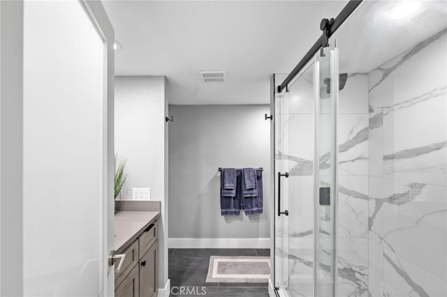 bathroom featuring baseboards, visible vents, vanity, and a marble finish shower