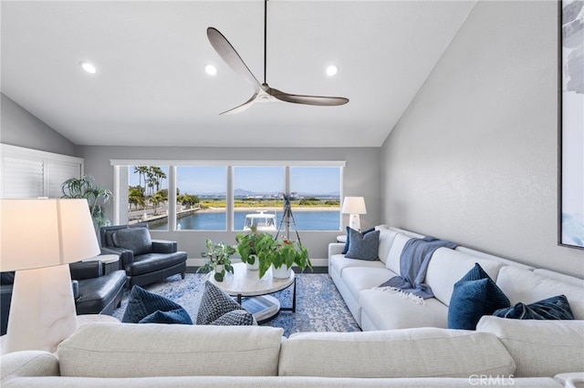 living room with lofted ceiling, recessed lighting, a water view, baseboards, and ceiling fan
