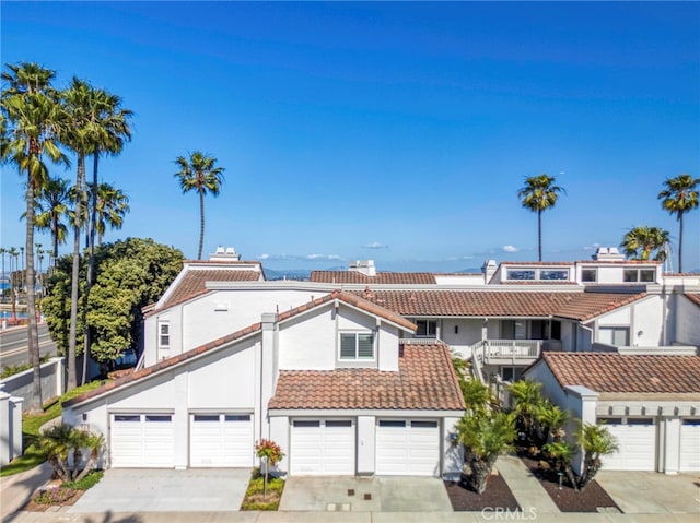 6 Kingston Ct E, Coronado, CA 92118 - view of front of property with a tile roof, stucco siding, driveway, and a garage