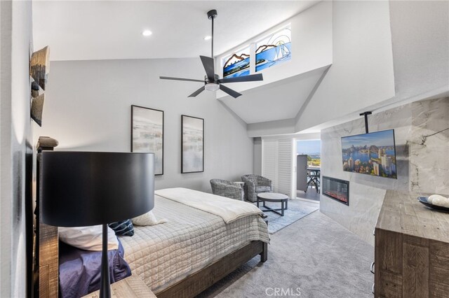 bedroom with recessed lighting, a ceiling fan, lofted ceiling, carpet floors, and a glass covered fireplace