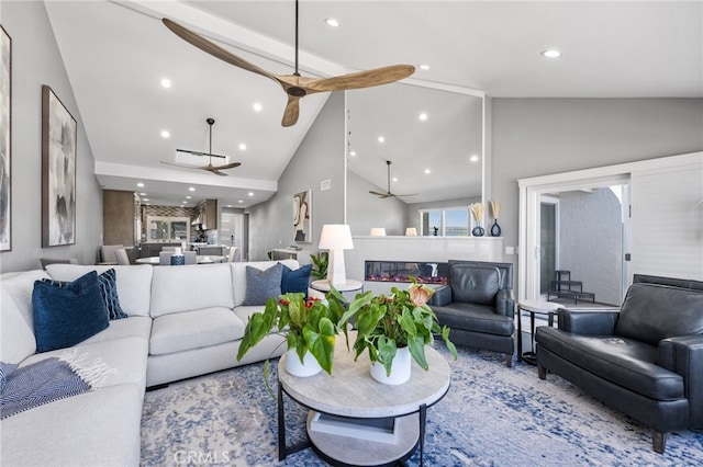 living room with beamed ceiling, high vaulted ceiling, and ceiling fan