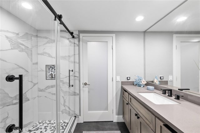 bathroom with a shower with door, vanity, and a baseboard radiator