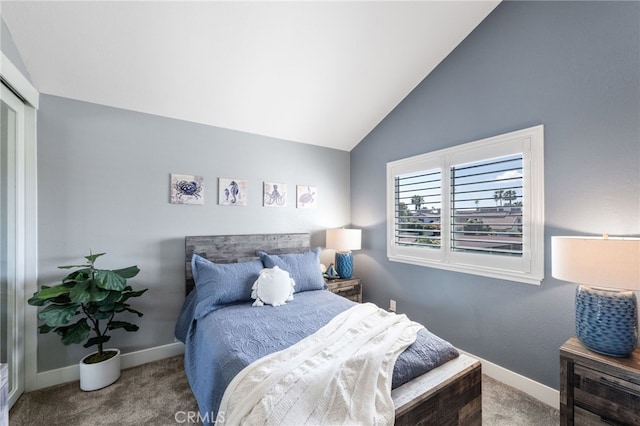 bedroom with baseboards, vaulted ceiling, and carpet