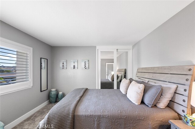 carpeted bedroom featuring baseboards