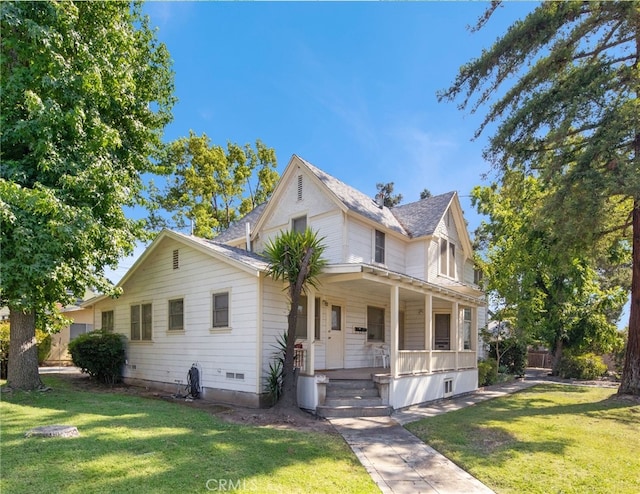 view of front facade with a front lawn and a porch