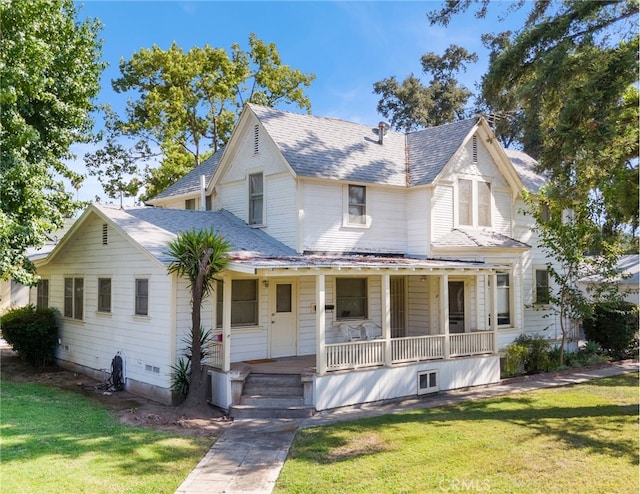 victorian house with covered porch and a front yard