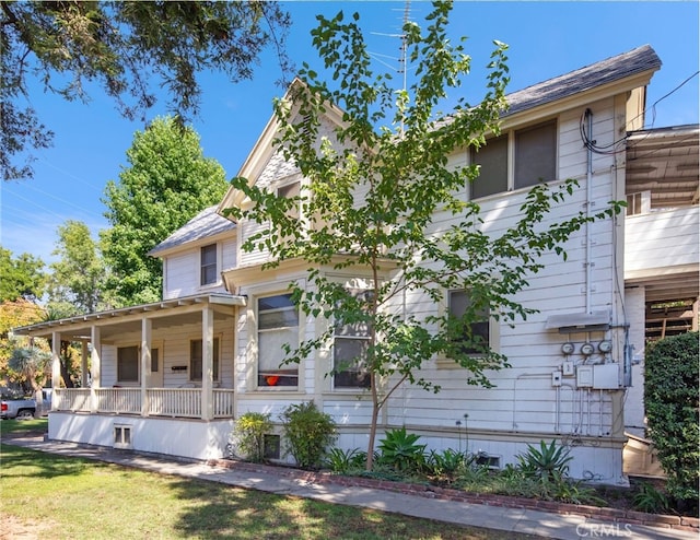 exterior space featuring a porch and a front lawn