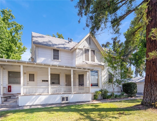 victorian home featuring covered porch and a front lawn