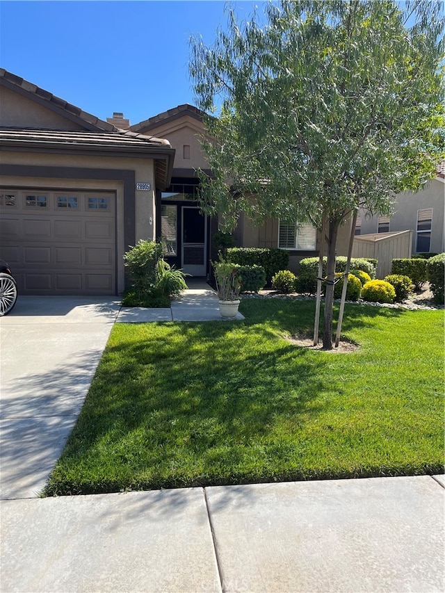 view of front of property with a front yard and a garage