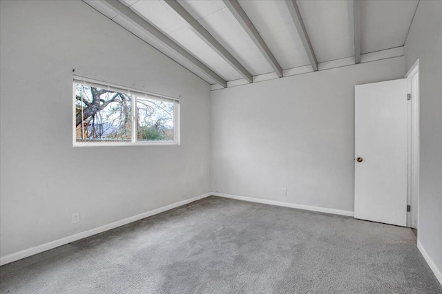 carpeted empty room featuring lofted ceiling with beams